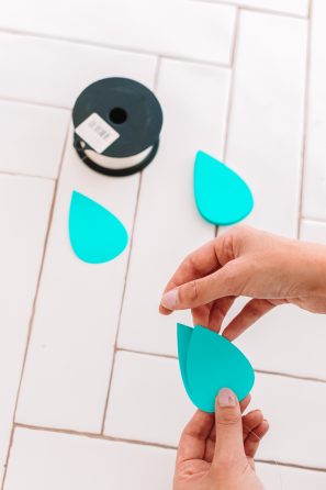 Someone holding paper raindrops