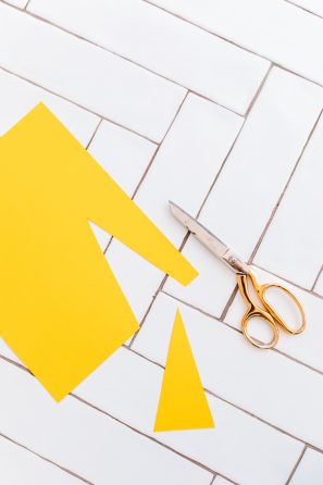 Someone cutting yellow paper