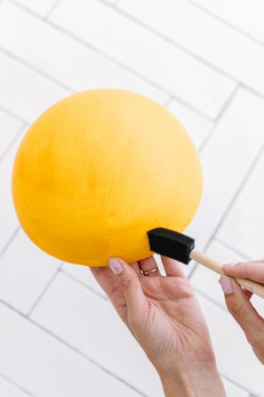 Someone painting a yellow dome