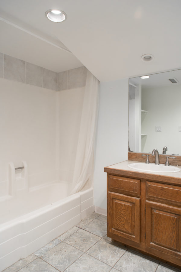 A bathroom with a sink and a shower