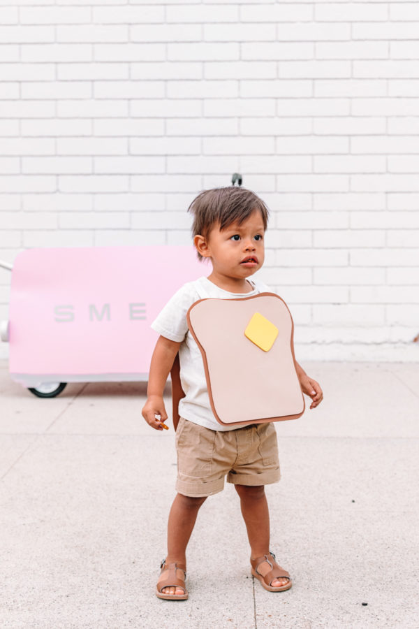 A little boy dressed as toast