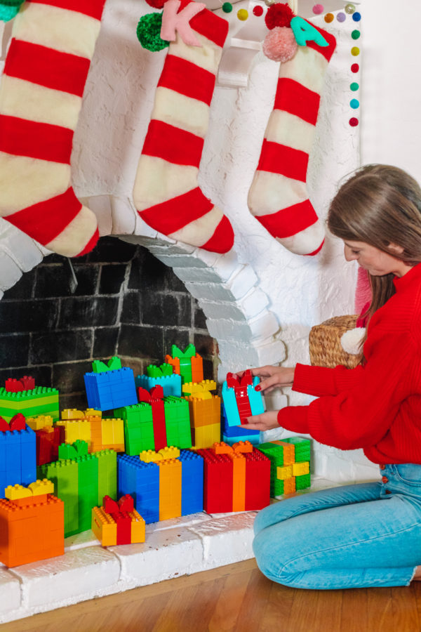 A person holding lego presents