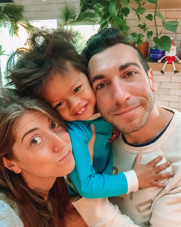 Parents and a child posing for the camera