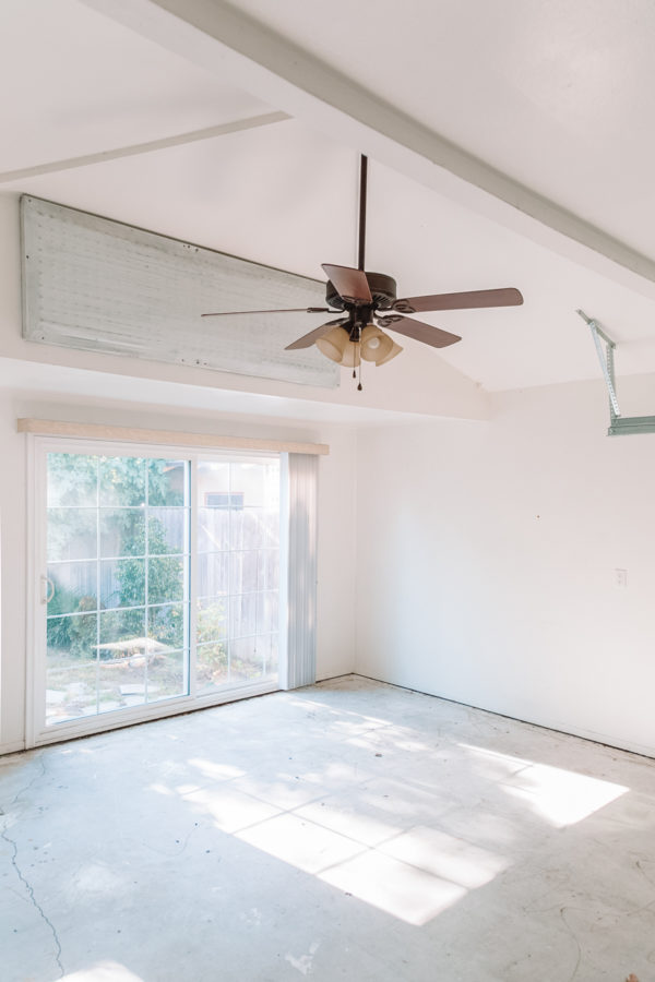 An empty room with a fan