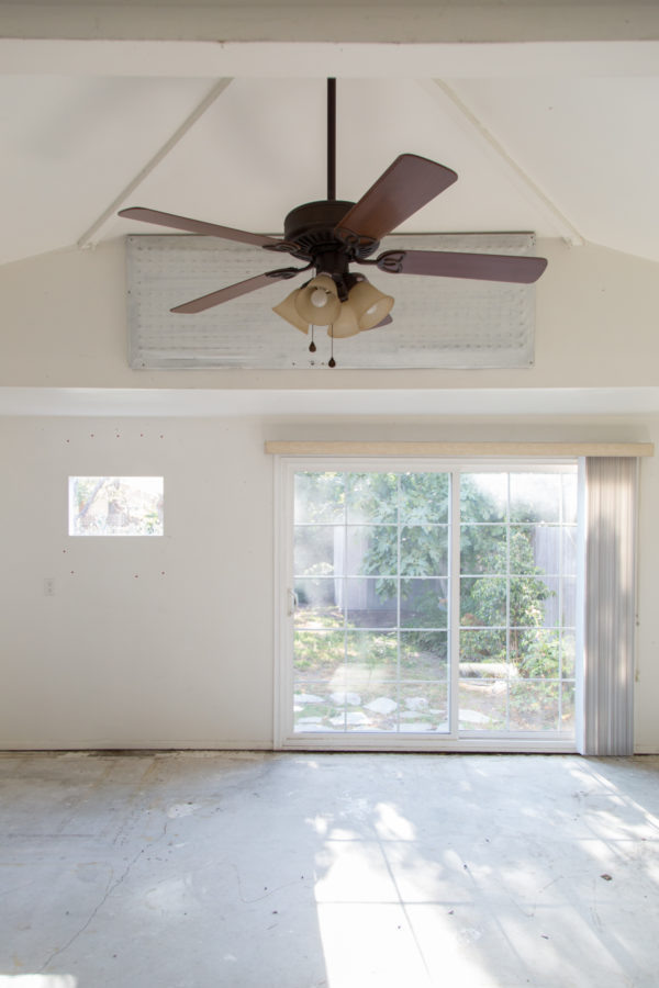 An empty room with a fan