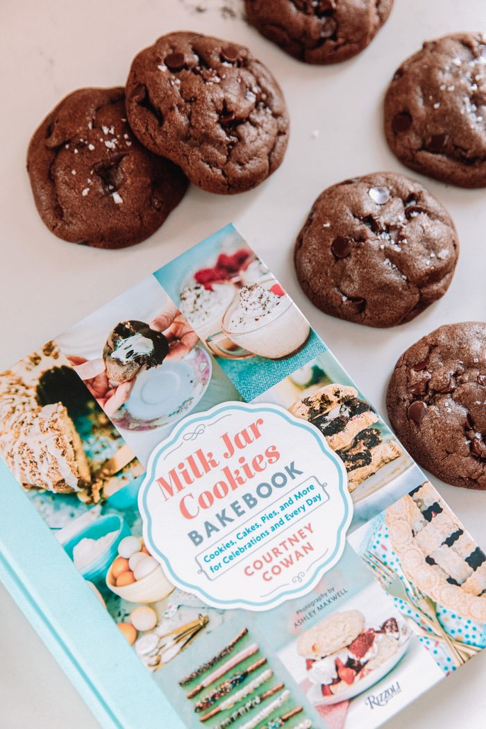 Chocolate chip cookies next to a book about cookies