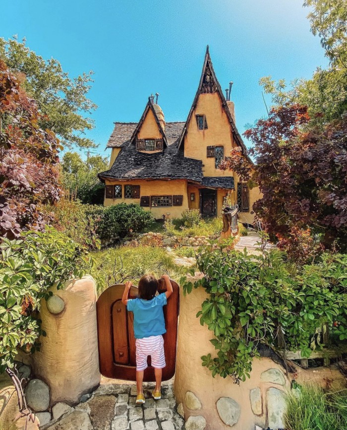 Spadena House in Beverly Hills with child looking over the gate