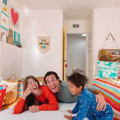 A Review of 2020 + What To Expect in 2021! A group of people sitting on a bed laughing