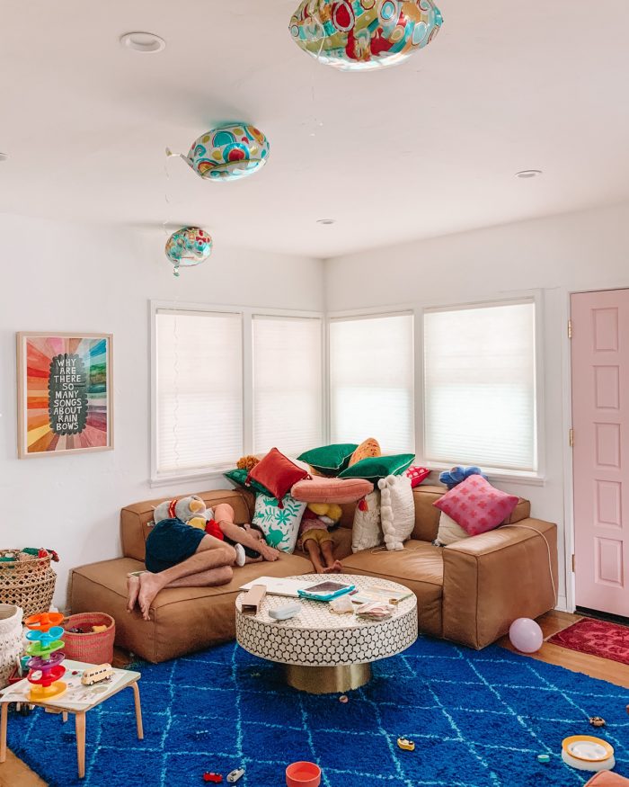 A living room with a pillow fort on the couch