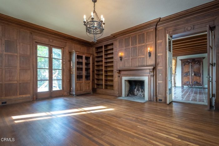 A living room with a fireplace and a large window