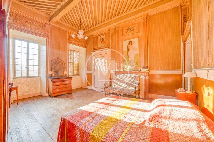 A bedroom with a bed and windows