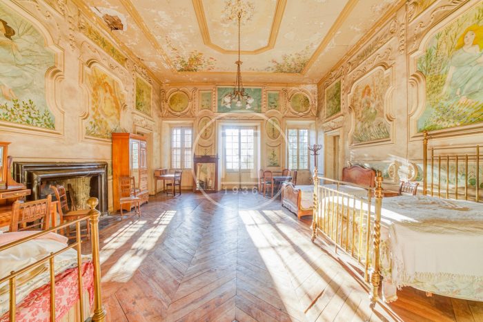 A bedroom with wood floors and two beds