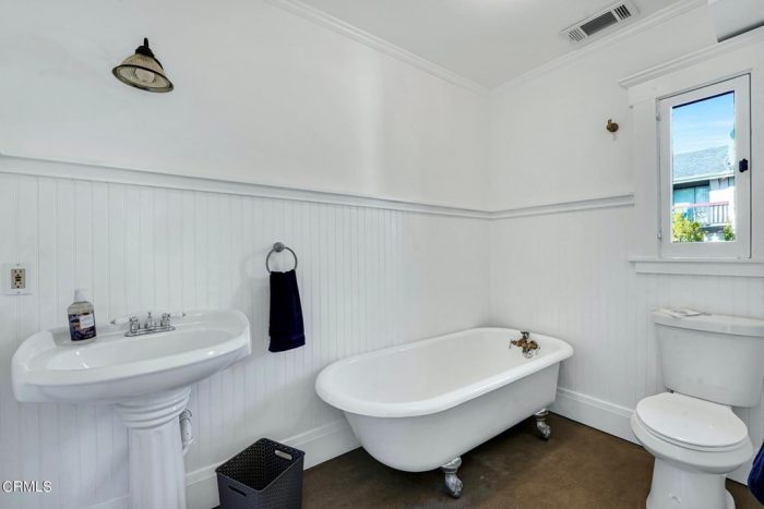 A room with a sink and a bathtub