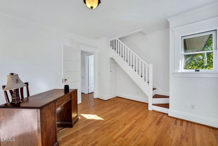 A room with a desk and staircase