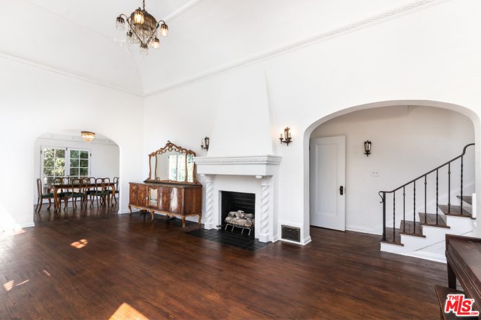 A living room with a wood floor and fire place