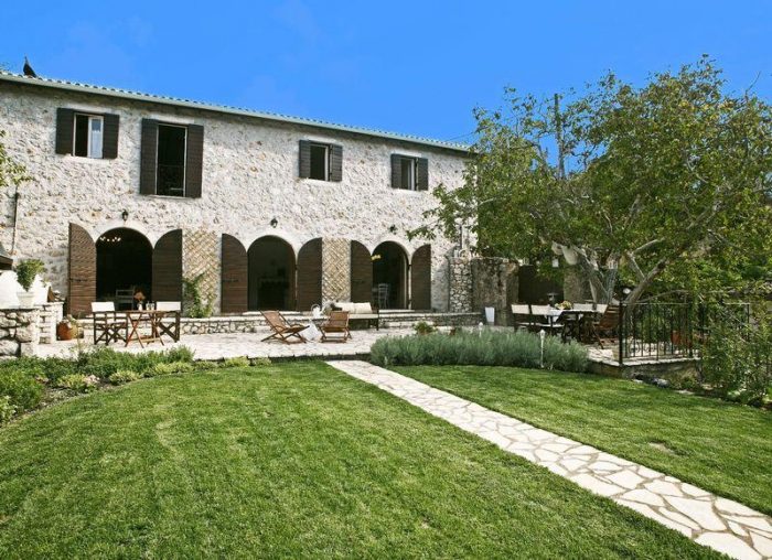 A house with windows and with grass in front of it