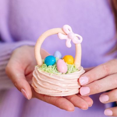 Meringue Easter Baskets A hand holding a small easter basket