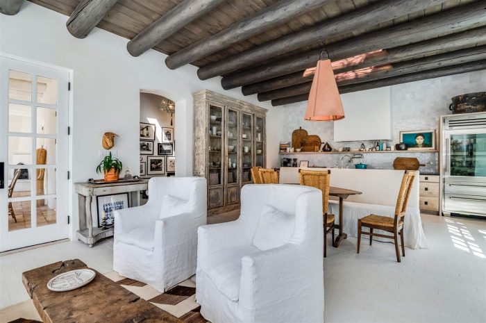 A living room filled with chairs and a bookcase