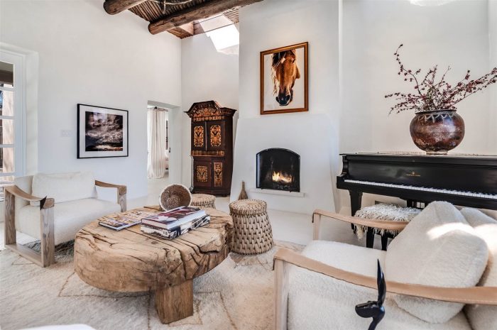 A whtie living room filled with furniture and a fire place