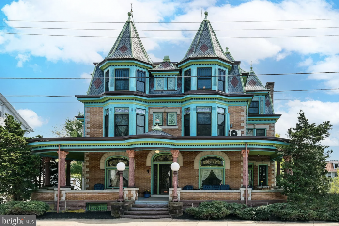 A victorian style building with bricks and blue paint