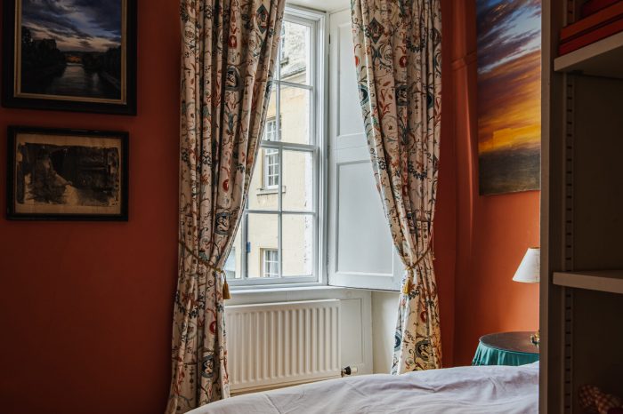 A bedroom with a bed and a window