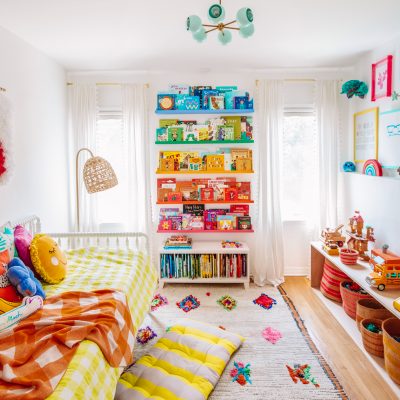 Arlo's Rainbow "Big Kid" Room A bedroom with rainbow bookshelves