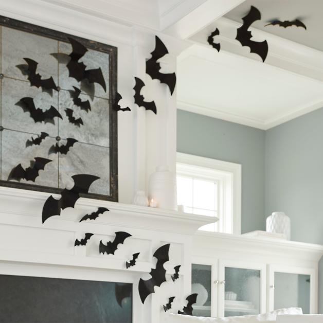 Felt bats on a white mantle and ceiling in a living room