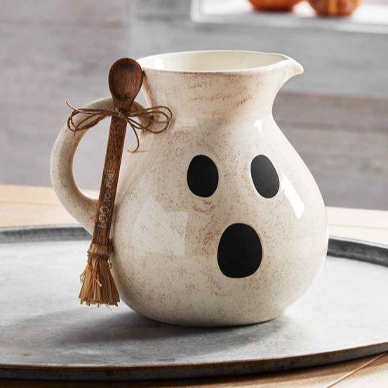 Ghost pitcher with wooden spool on a large tray