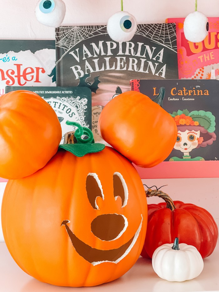 Mickey pumpkin in front of Halloween books