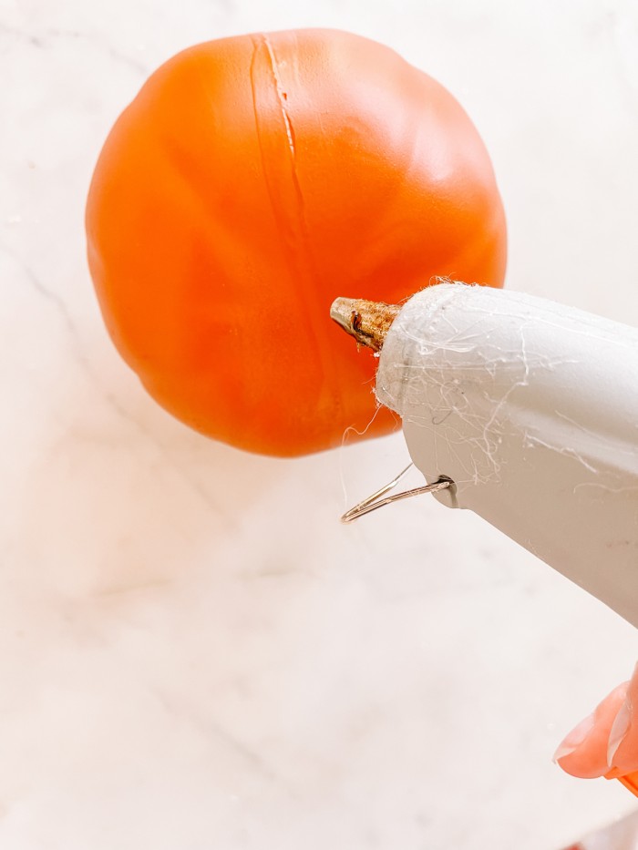 small pumpkin with hot glue gun in front
