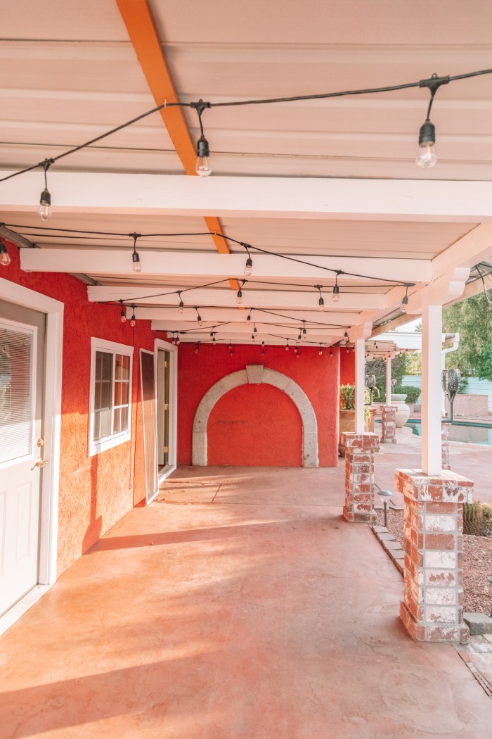 Outdoor pergola with red wall