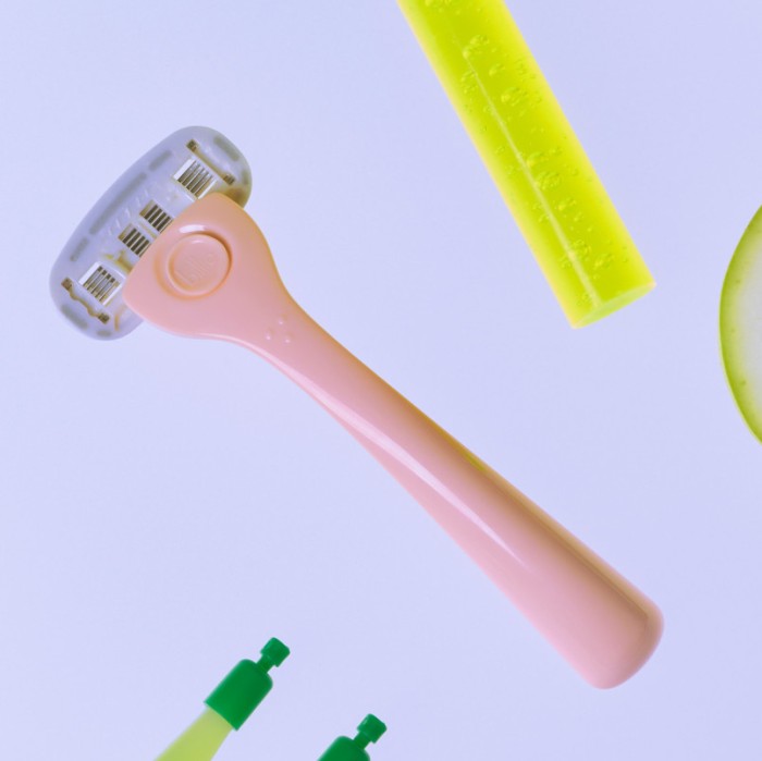 Pink razor on purple background