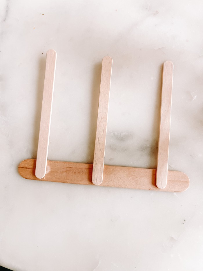 Popsicle sticks glued together on marble table