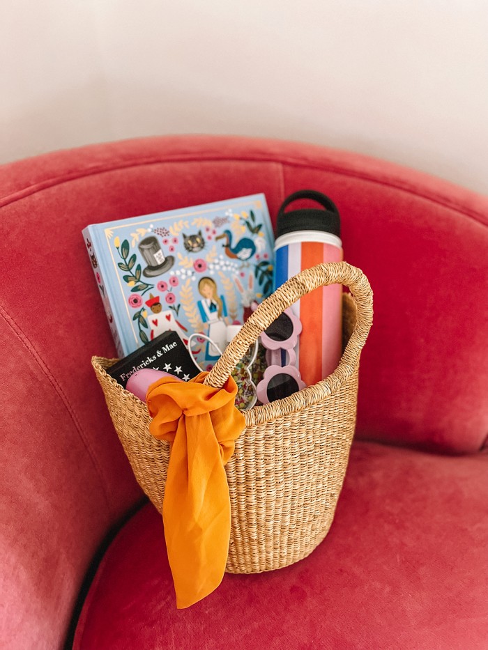 easter basket with book, water bottle and sunglasses