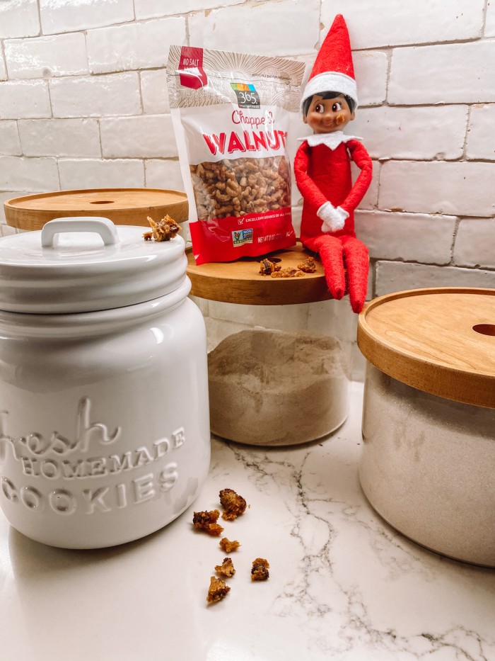 elf sitting on jar with crumbs on face