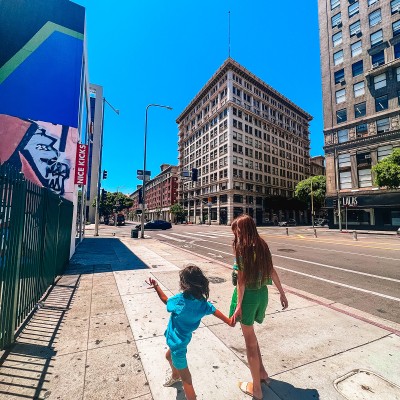Happy Weekend! woman and child walking down street in Downtown Los Angeles