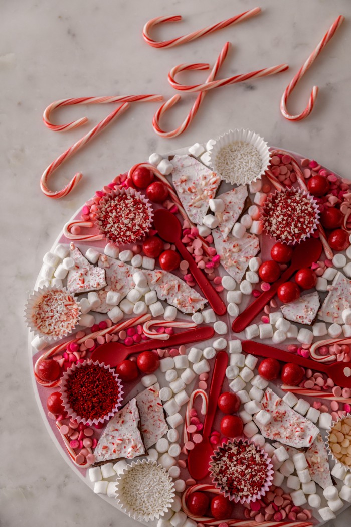 Christmas Hot Chocolate Board Overhead shot of a hot chocolate board with red and white hot chocolate toppings.