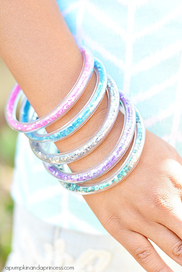 Glitter bracelets on child's arm.
