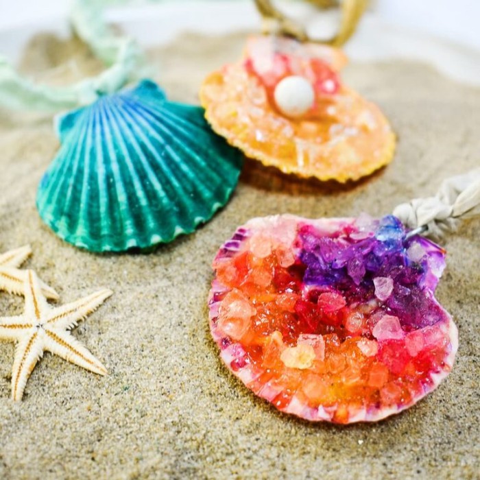 Seashell necklaces on sand.
