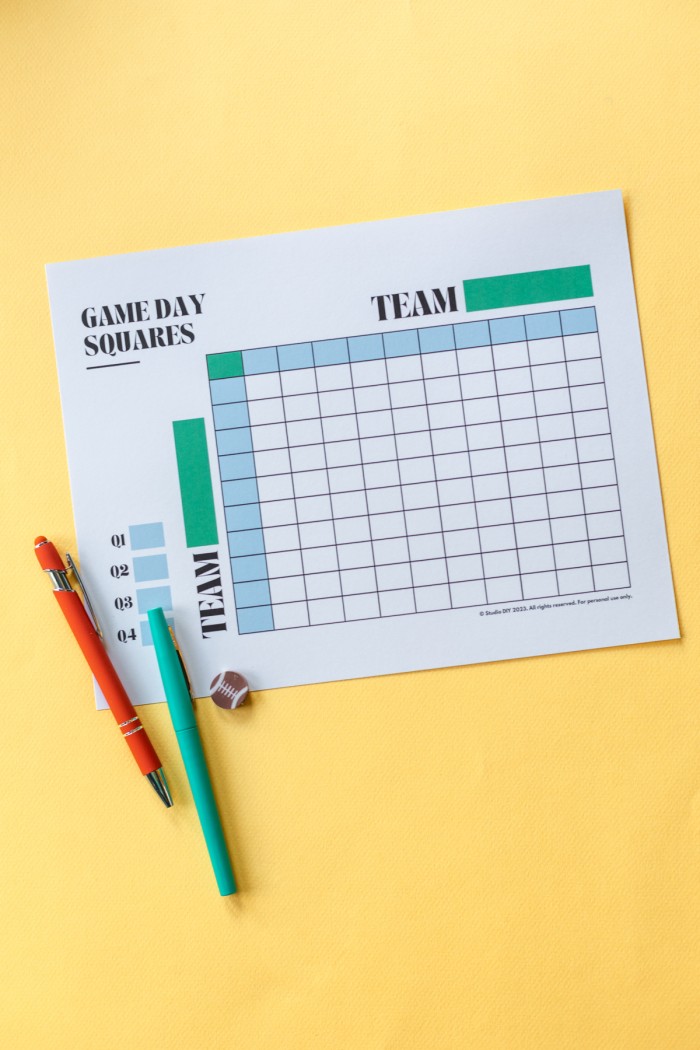 How to Use Football Squares Paper with football game squares and pens next to it on a yellow background.
