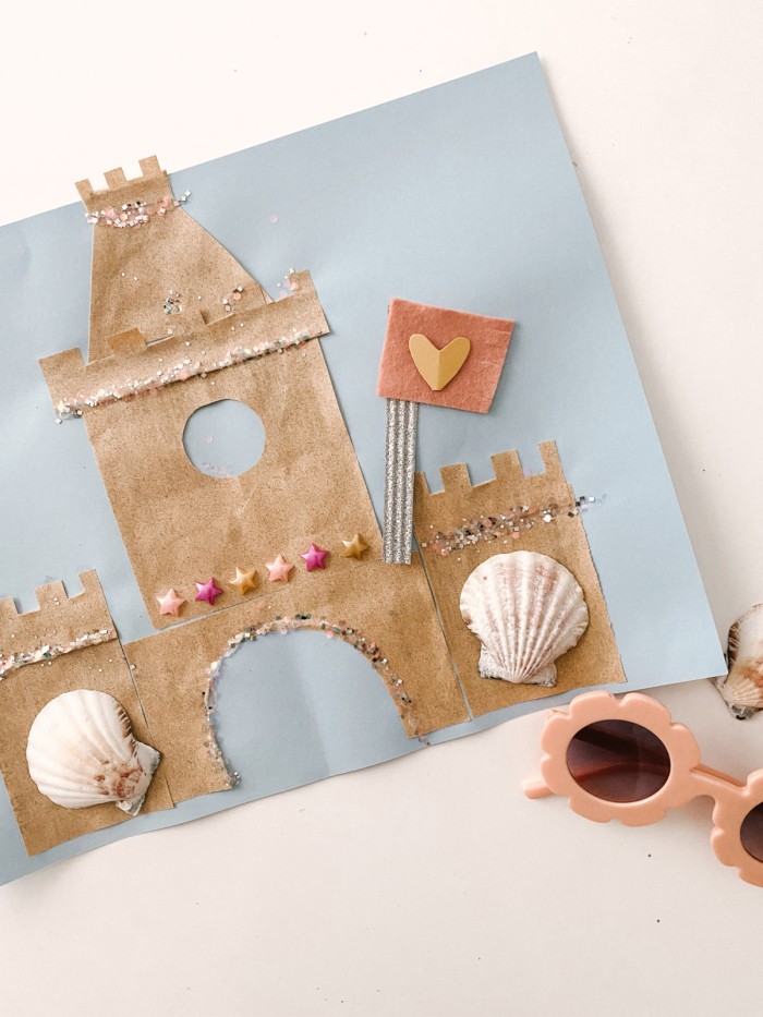 Sand paper sand castle art picture on a table.