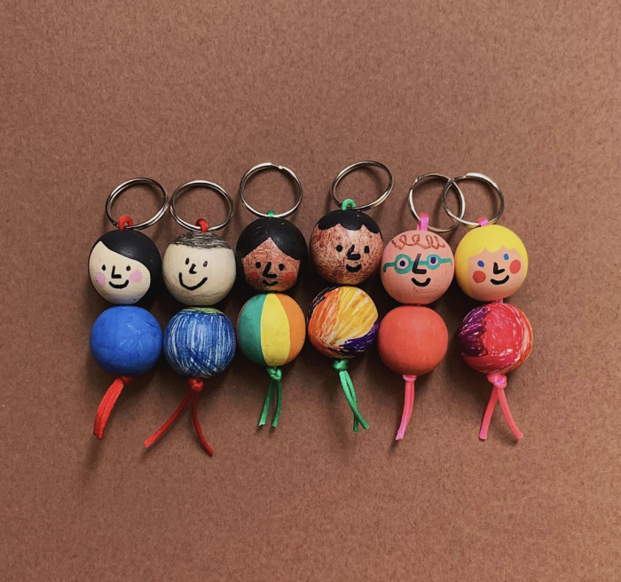 Homemade keychains decorated as little people.