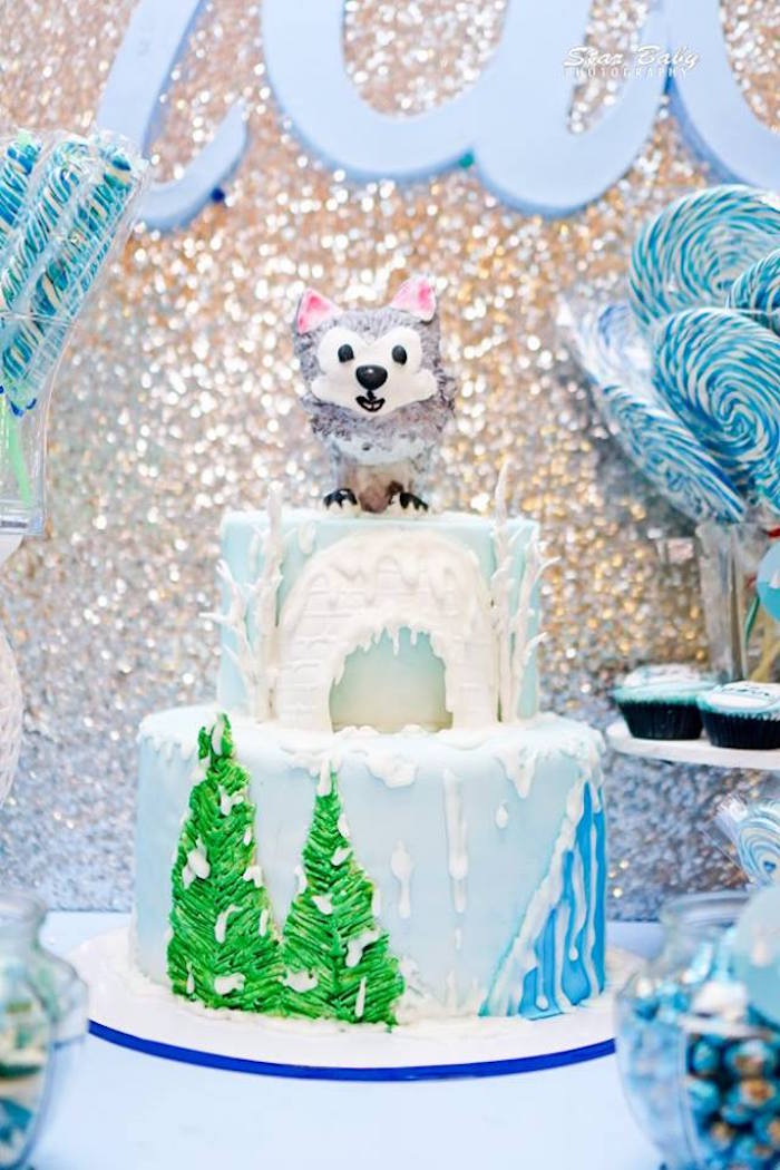 Tiered cake with an animal shape on top. 