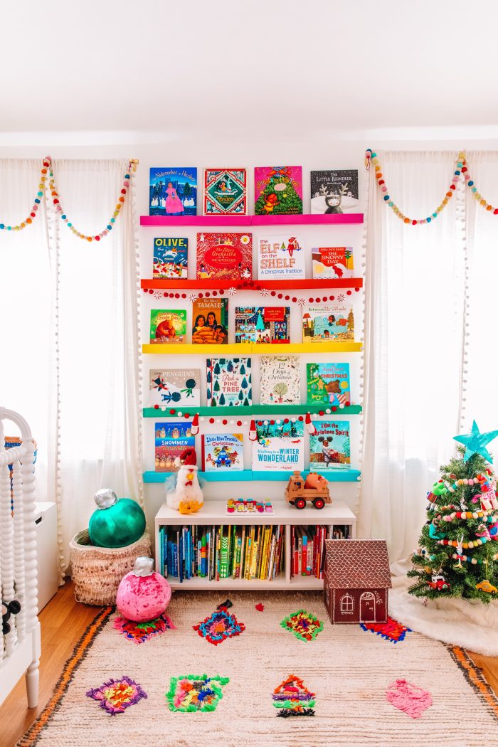Best Christmas Bucket List Ideas Photo of a child's room with a book self on the wall displaying Christmas books.