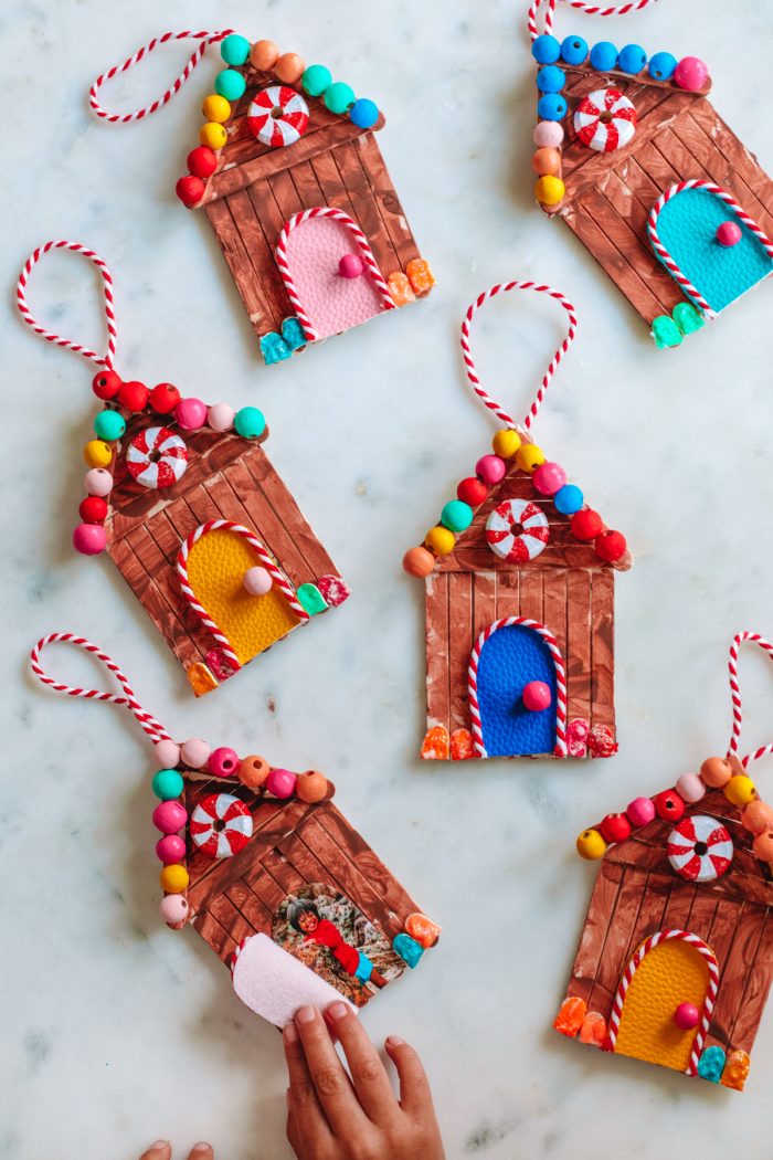 Ideas for Christmas Bucket List Overhead shot of gingerbread house ornaments on a marble background.