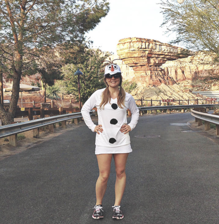 Olaf Christmas Costume Woman standing in a road, dressed as Olaf the snowman.