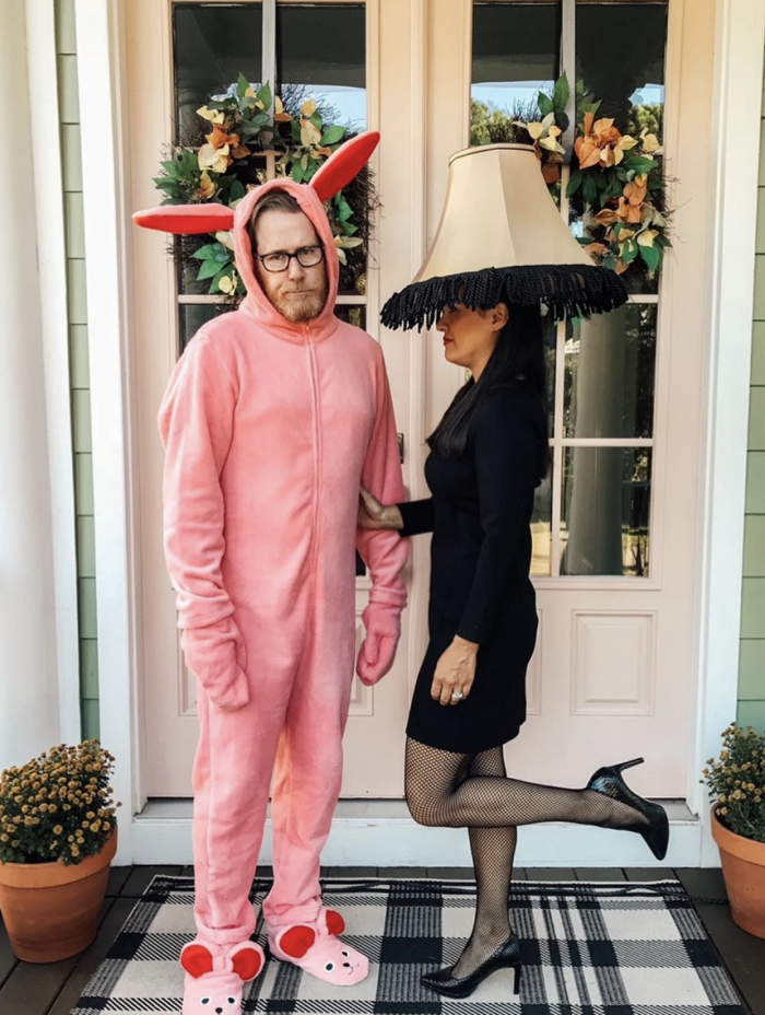 A Christmas Story Costumes Man dressed as a bunny and woman dressed as a lamp, both standing in front of a door.