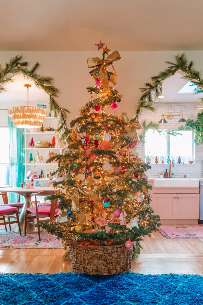 Fun Christmas Bucket List Ideas Photo of a living room with a Christmas tree and more Christmas decorations around the house.