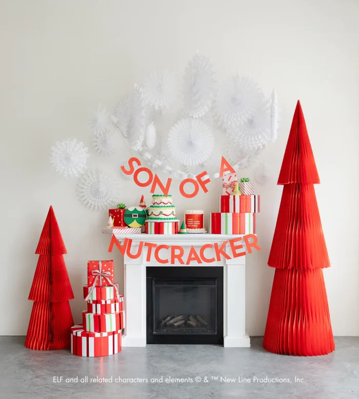 Elf quote decorated on the mantle with red paper trees next to the mantle as well. 