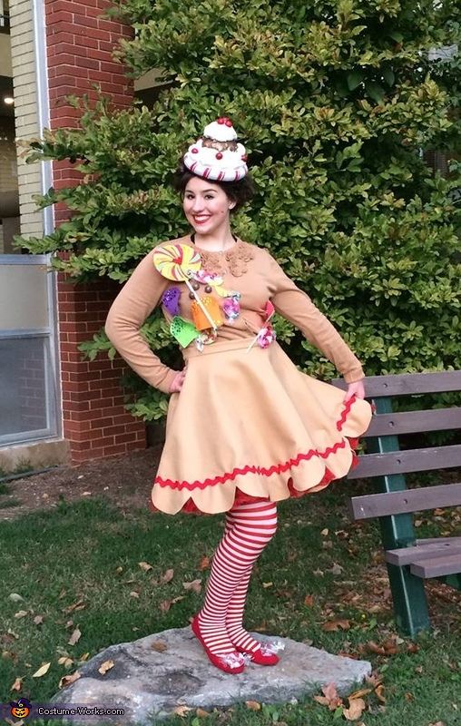 Gingerbread Christmas Costume Woman standing outside dressed as a gingerbread girl with striped stockings.